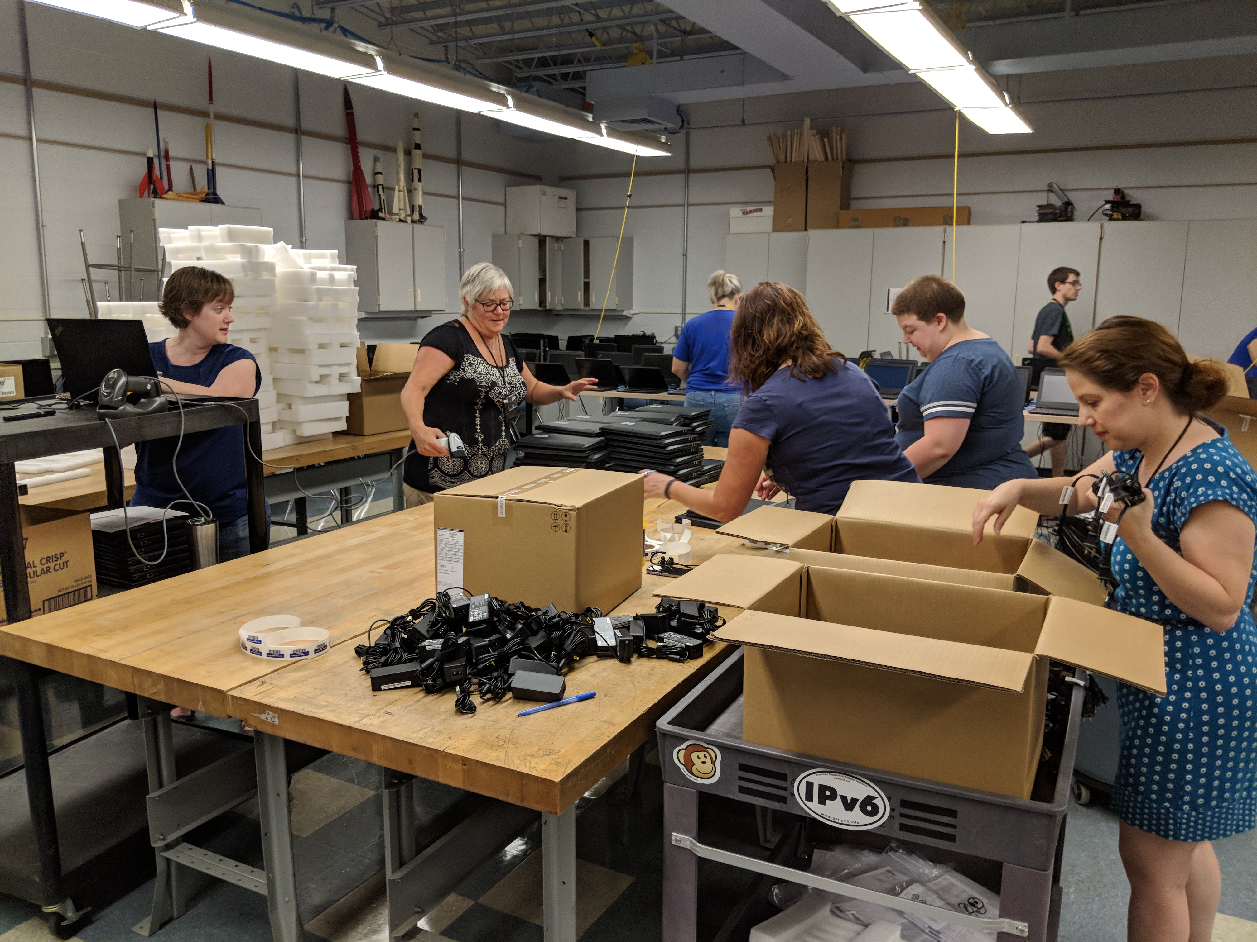 Tech team unboxing laptops.